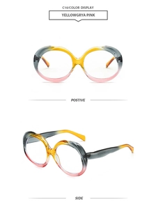 Detail view of oval gradient sunglasses in yellow, grey, and pink acetate frames