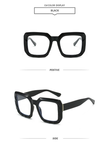 Detail view of bold rectangle sunglasses with glossy black frames and wide temples