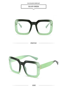 Detail view of large rectangular sunglasses with black and green gradient frames