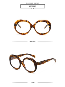 Detail view of oval leopard print sunglasses showing front and side thick frame frames