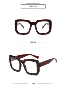 Detail of wine red rectangular frame with thick resin finish and gold metal hinges