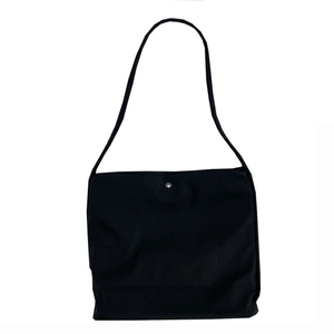 Minimalist black nylon canvas tote bag with a silver magnetic button for daily commuting