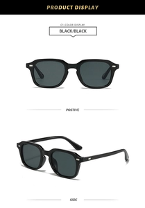 Détail de lunettes de soleil carrées noires avec rivets en argent et verres foncés