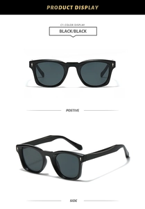 Close-up of black square sunglasses with dark grey lenses and golden arrow metal accents