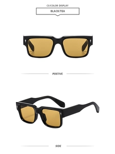 Macro detail of black square sunglasses with yellow lenses and silver diamond rivets