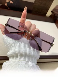 Close-up of rimless square sunglasses with purple gradient lenses and gold metal temples