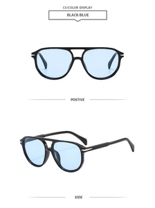 Classic double-bridge pilot sunglasses with black frame and light blue lenses in macro view