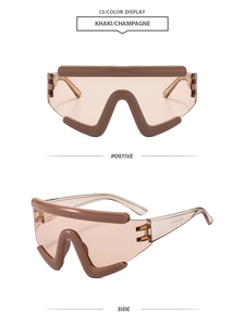 Detail view of khaki champagne oversized shield sunglasses with a modern geometric frame