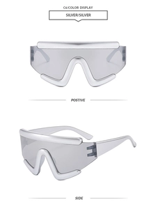 Detail of silver futuristic oversized wrap sunglasses with metallic frame and gray lenses