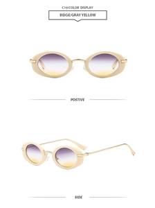 Detail view of oval beige sunglasses with gold metal temples and gradient lenses