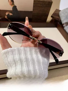Detailed shot of rimless oval sunglasses with purple gradient lenses and gold temples