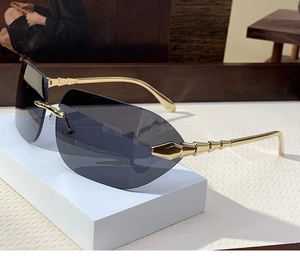 Detail of rimless square sunglasses with grey lenses and gold bamboo style temples
