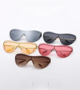 Multiple colors of rimless shield sunglasses with slim gold metal temples on white backdrop