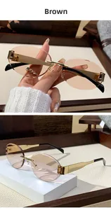 Detail view of rimless brown oval sunglasses with gold metal temples and black tips