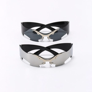 Futuristic Y2K rimless bat wing sunglasses in black and silver mirror finish lenses