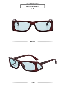 Detail view of wine red rectangle sunglasses with hollow side frame and green lenses