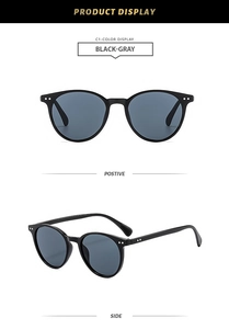 Detail view of round black frame sunglasses with gray lenses and silver rivet accents