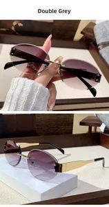 Detail of rimless oval sunglasses with purple-grey gradient lenses and gold metal temples