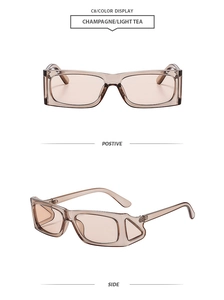 Detail of champagne rectangle sunglasses featuring side wing design and tinted lenses