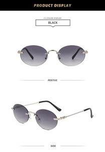 Détail de lunettes de soleil rondes sans monture avec verres dégradés et branches gravées