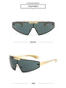 Close-up of golden metal frames and green shield lenses of these futuristic sunglasses