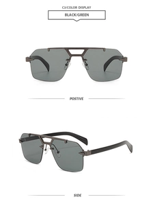 Close-up of retro double-bridge sunglasses with black-green lenses and metal frame
