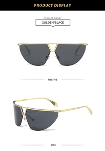 Detail of semi-rimless sunglasses with gold metal double bridge and oversized black lens