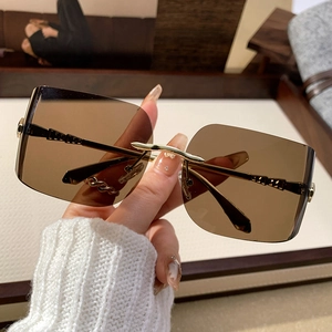 Fashionable rimless square sunglasses with brown gradient lenses and gold metal temples