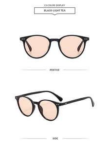 Retro round sunglasses with black frames, light tea lenses and metal rivets detail