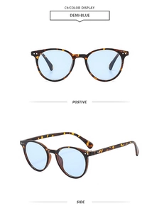 Detail view of round tortoiseshell sunglasses with demi-blue lenses from front and side