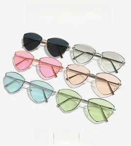 Flat lay of rimless geometric triangle sunglasses with gold metal frames in diverse colors