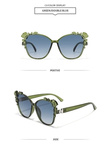 Detail view of green butterfly sunglasses with diamond accents and blue gradient lenses