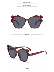 Detailed views of wine red cat-eye sunglasses with rhinestone accents and dark lenses