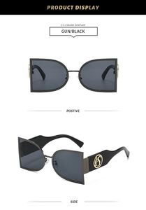 Detail view of gunmetal sunglasses showing unique frame shape and side metal S logo