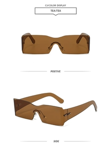 Detail of Y2K rimless wrap sunglasses featuring tea-tinted lens and silver metal nose pads