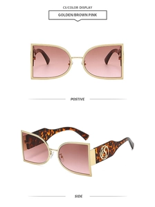 Detail view of semi-circular metal sunglasses with gradient lenses and leopard temples