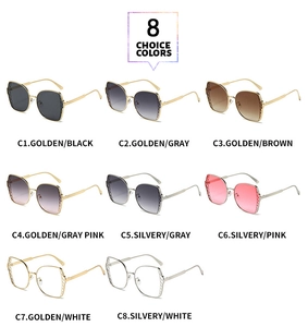 Detail view of large polygon metal sunglasses featuring textured diamond-pattern temples