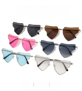 Flat lay of multiple colorful heart-shaped geometric sunglasses with sleek metal frames