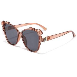 Fashionable amber oversized sunglasses with crystal bow accents and dark lenses