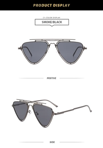 Detail view of double-bridge metal aviator sunglasses with smoke gray lenses