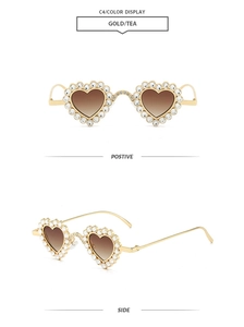 Detail of heart sunglasses with gold frame, rhinestone trim and tea gradient lenses