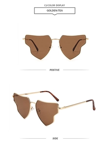 Detail view of golden irregular metal frame sunglasses with tea lenses and tortoise tips