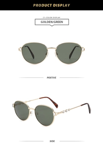 Detail view of retro round metal sunglasses with green lenses and crystal inlay