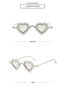 Detail view of heart-shaped sunglasses with sparkling rhinestones on silver metal frames