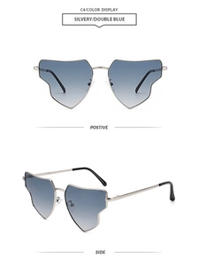 Close-up of irregular heart-shaped rimless sunglasses with blue gradient lenses and silver frames