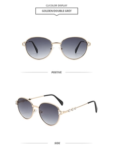 Detail view of round gold metal sunglasses with crystal decor and grey gradient lenses