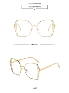 Detail of oversized gold frames with geometric hollow mesh texture on side temples