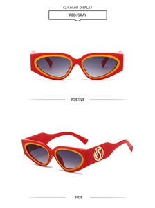 Detail view of Y2K cat-eye sunglasses featuring red and yellow frames with golden S logo