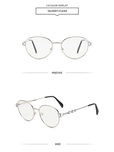 Detail view of silver metal oval sunglasses with blue gemstone accents and C4 color code