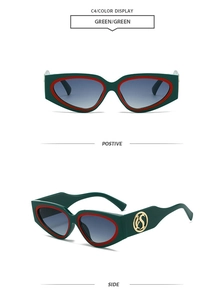 Detail view of Y2K cat eye sunglasses in dark green with red accents and golden logo